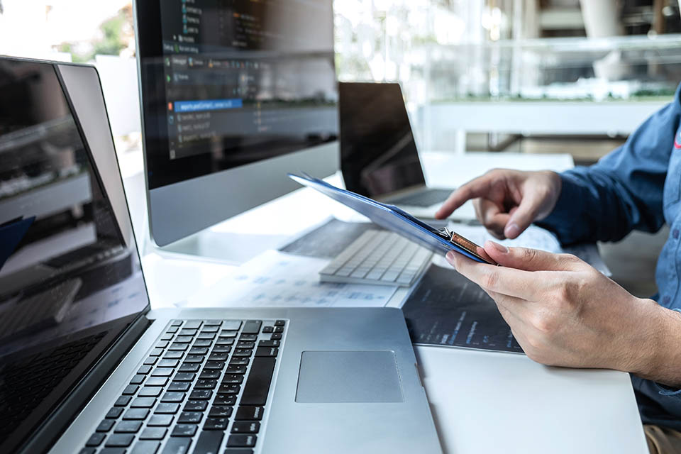 Developer programmer working on project in software development computer in IT company office, Writing codes and data code website and coding database technologies to find solution to problem